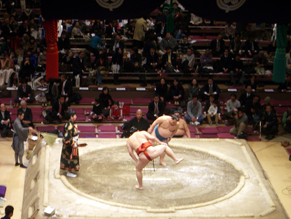 futenno3web Two sumo wrestlers begin the leg-stomping shiko ritual in the ring