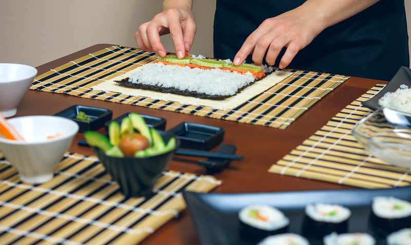 Japanese chef making a sushi roll