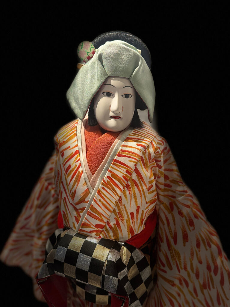 Bunraku puppet against black background