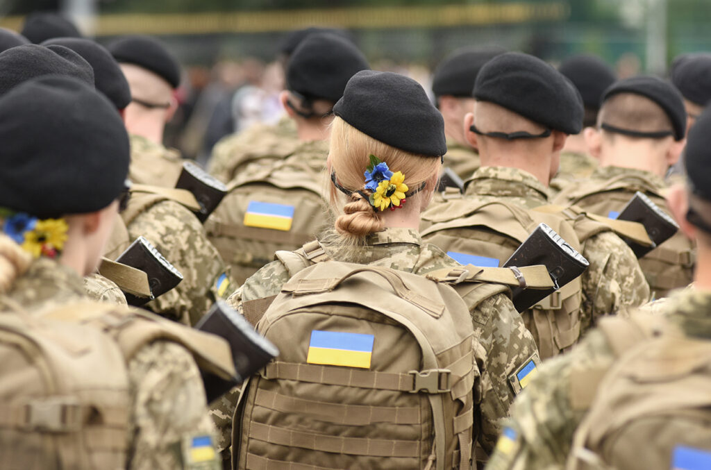 Woman soldier. Woman in army. Ukrainian flag on military uniform. Ukraine troops.