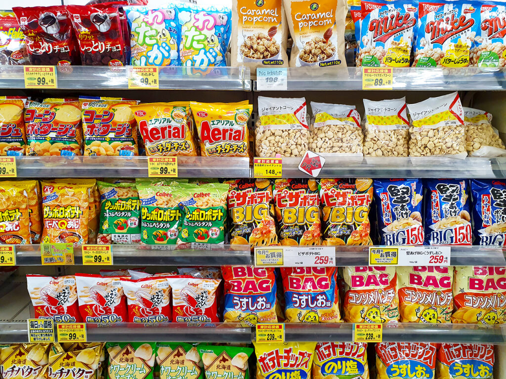 Yamanashi, JP - OCTOBER 4, 2019: Various of Japanese snacks and candies in colorful packaging, sell on a shelf in the local snack shop for kids.